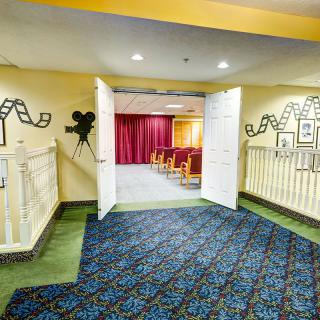 A small indoor cinema with film-themed decorations and seating.