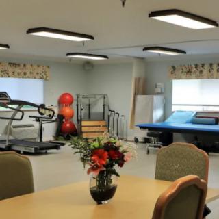A physical therapy room equipped with exercise machines and rehabilitation tools.