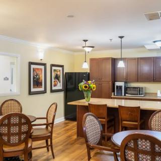 A cozy kitchen and dining area with warm lighting and wooden furniture.