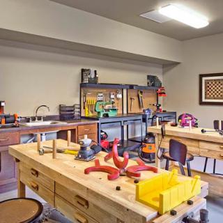 A well-equipped workshop with various tools and work tables ready for crafting and woodworking activities.
