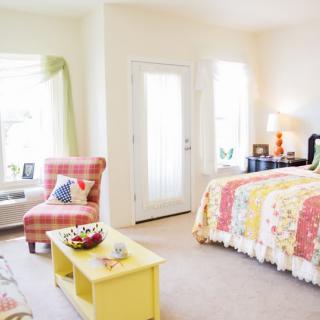 A cozy and colorful bedroom with bright natural light.