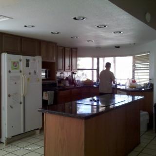 A spacious kitchen with an island counter and large windows.