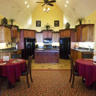 A spacious kitchen and dining area featuring wooden cabinets and modern appliances.