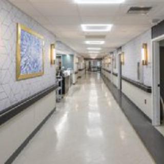 A clean and well-lit hospital corridor with medical equipment.
