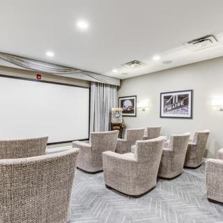 A modern home theater setup with comfortable seating and a large screen, perfect for movie nights.
