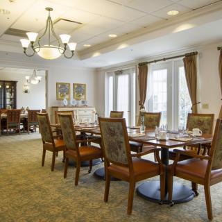 A well-appointed dining room with elegant furniture and a chandelier.