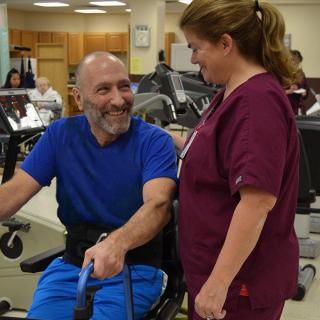 A patient and nurse engaging in a rehabilitation session at a healthcare facility.