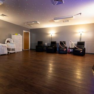 A modern waiting room featuring comfortable recliners and soft lighting, designed for relaxation.