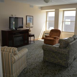 A cozy living room featuring comfortable seating and a TV.