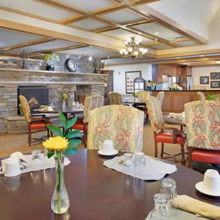 A cozy dining room with elegant decor and a welcoming fireplace.