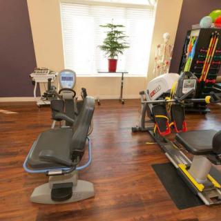 A well-equipped gym with exercise machines and a variety of fitness tools.