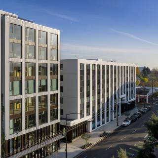 A modern office building in an urban setting during the day.