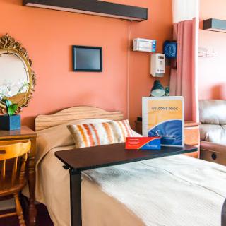A cozy patient room designed to provide comfort with warm colors and essential amenities.