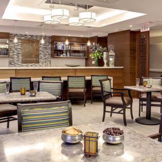 A modern dining area featuring elegant furniture and ambient lighting.