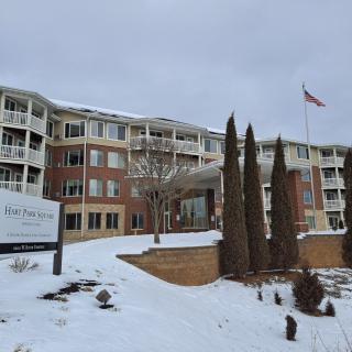 A snow-covered facility with an American flag flying outside.