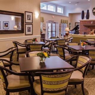 A cozy dining area with neatly arranged tables and chairs, adorned with decorative elements.