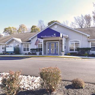 Exterior view of a motel or hotel on a sunny day.
