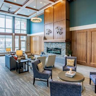 A modern and cozy lobby with comfortable seating and a fireplace.