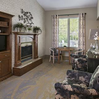 Cozy living room with a fireplace, television, and comfortable seating.
