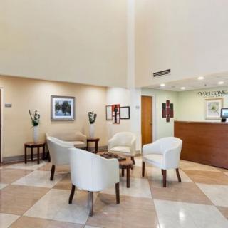 A modern hotel lobby with a seating area and reception desk.