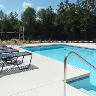 A serene outdoor swimming pool area, perfect for relaxation under the sun.