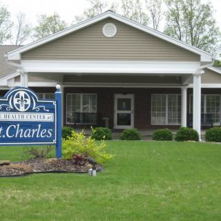 A suburban-style building with a sign on the lawn.