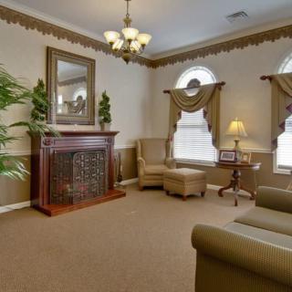 A classic-styled living room with elegant furnishings and warm lighting.