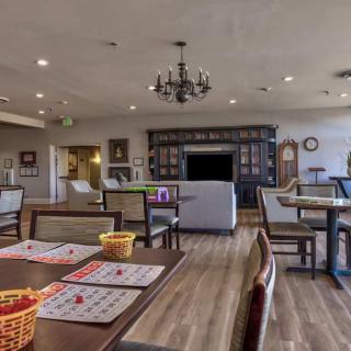 A cozy recreation room in a retirement home with tables set up for bingo.