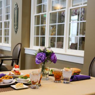 A beautifully arranged dining table with various dishes and a floral centerpiece.