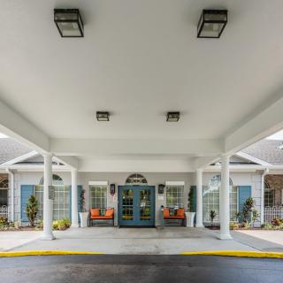 A building entrance with a covered awning and columns.