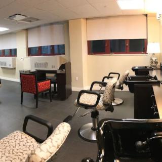 A modern salon interior with styling chairs and mirrors.