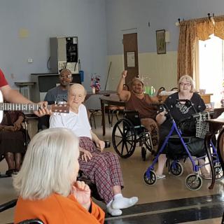 Residents enjoying a musical performance at a nursing home.