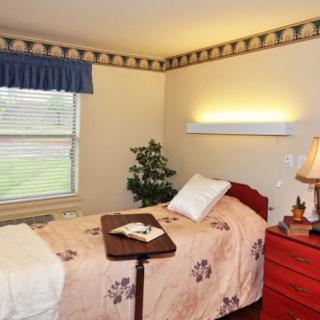 A cozy bedroom with a single bed, nightstand, and decorative elements.