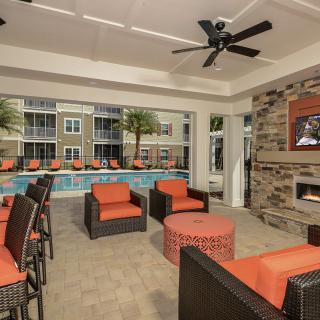 Modern indoor lounge area with pool view and comfortable seating.