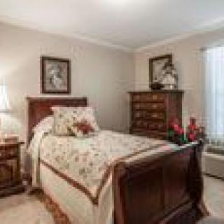 A cozy bedroom with traditional furniture and decorative accents.