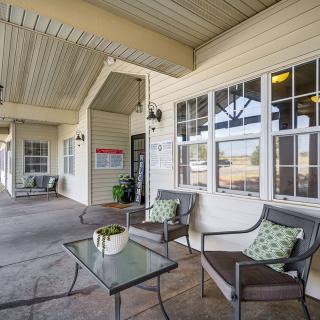 A cozy outdoor patio area with comfortable seating and decorative plants.