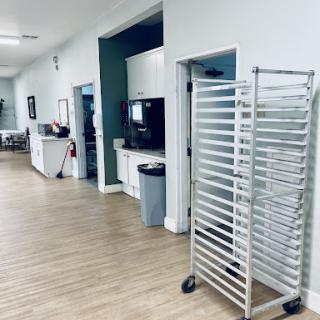 A view of a healthcare facility's waiting area with a kitchen cart positioned nearby.