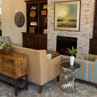 A modern living room with a cozy fireplace, stylish furniture, and tasteful artwork.