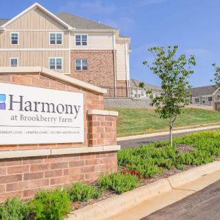 Exterior view of Harmony at Brookberry Farm with building sign and landscaping.
