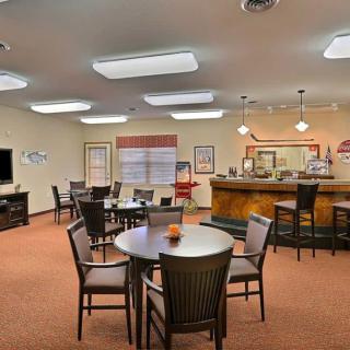 A cozy and modern cafe interior with a bar counter and seating area.