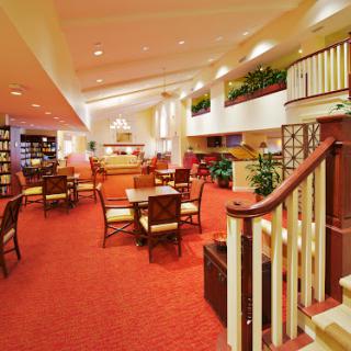 A spacious and inviting lobby area featuring comfortable seating, vibrant decor, and a welcoming atmosphere.