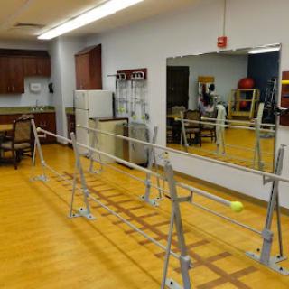 A rehabilitation facility featuring parallel bars for physiotherapy exercises.