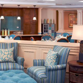 A cozy lounge area featuring striped chairs and soft lighting.