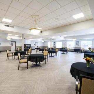 A spacious dining hall with neatly arranged tables and chairs.
