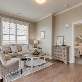 A cozy living room with a beige couch, coffee table, and elegant decor.