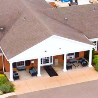 Aerial view of a building with a prominent entrance and patio.