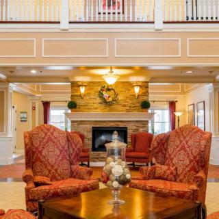A luxurious lobby with comfortable seating and a fireplace.