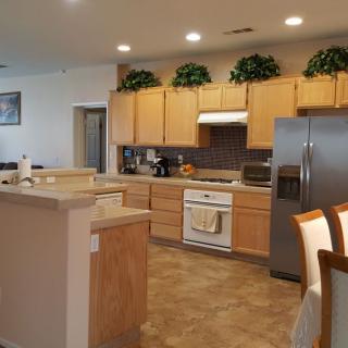 A spacious kitchen with wooden cabinets and modern appliances.