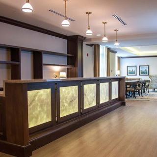 A modern hotel lobby featuring a well-lit reception desk and stylish interior design.