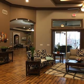 A modern lobby with comfortable seating and wood flooring.